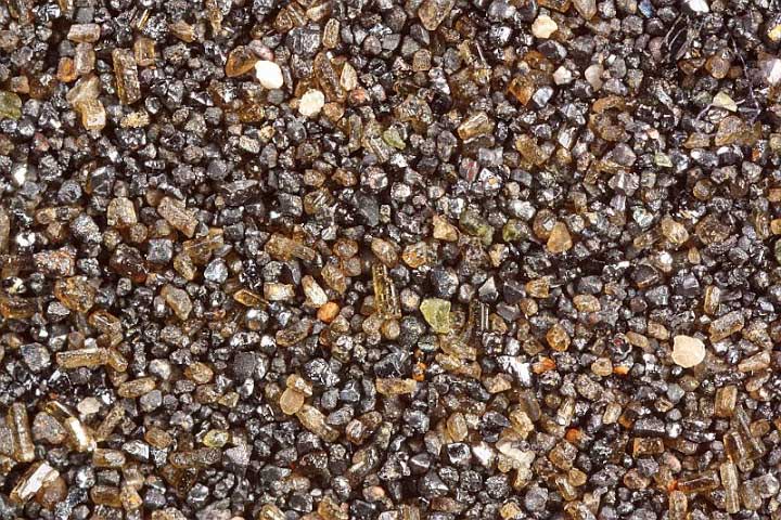 Volcanic minerals in beach sand of Martinique.