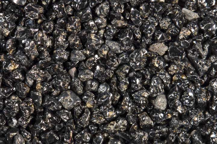 Black sand composed of volcanic glass.